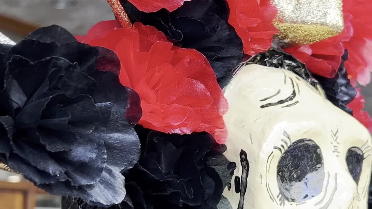 Life-size catrina decorated with brightly colored crepe paper for Day of the Dead celebrations