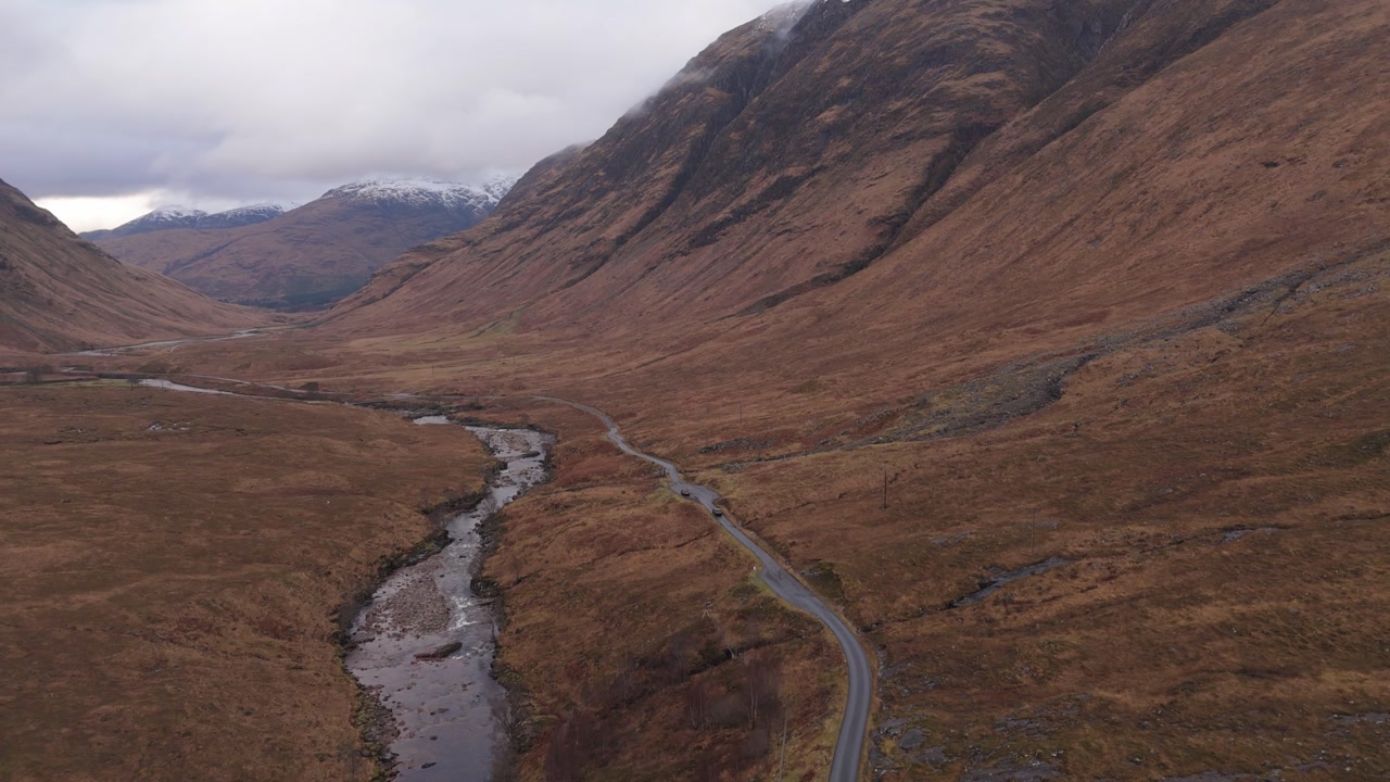 still video of a car driving on a cloudy day in Scotland