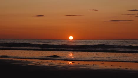 Man-running-with-guitar-in-back-sand-beach-at-sunset-29