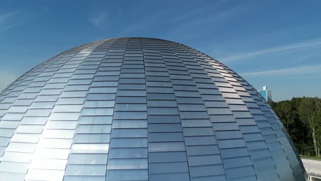 great stars observatory during a beautiful summer day, surrounded by lush greenery, grass, and trees under a clear blue sky