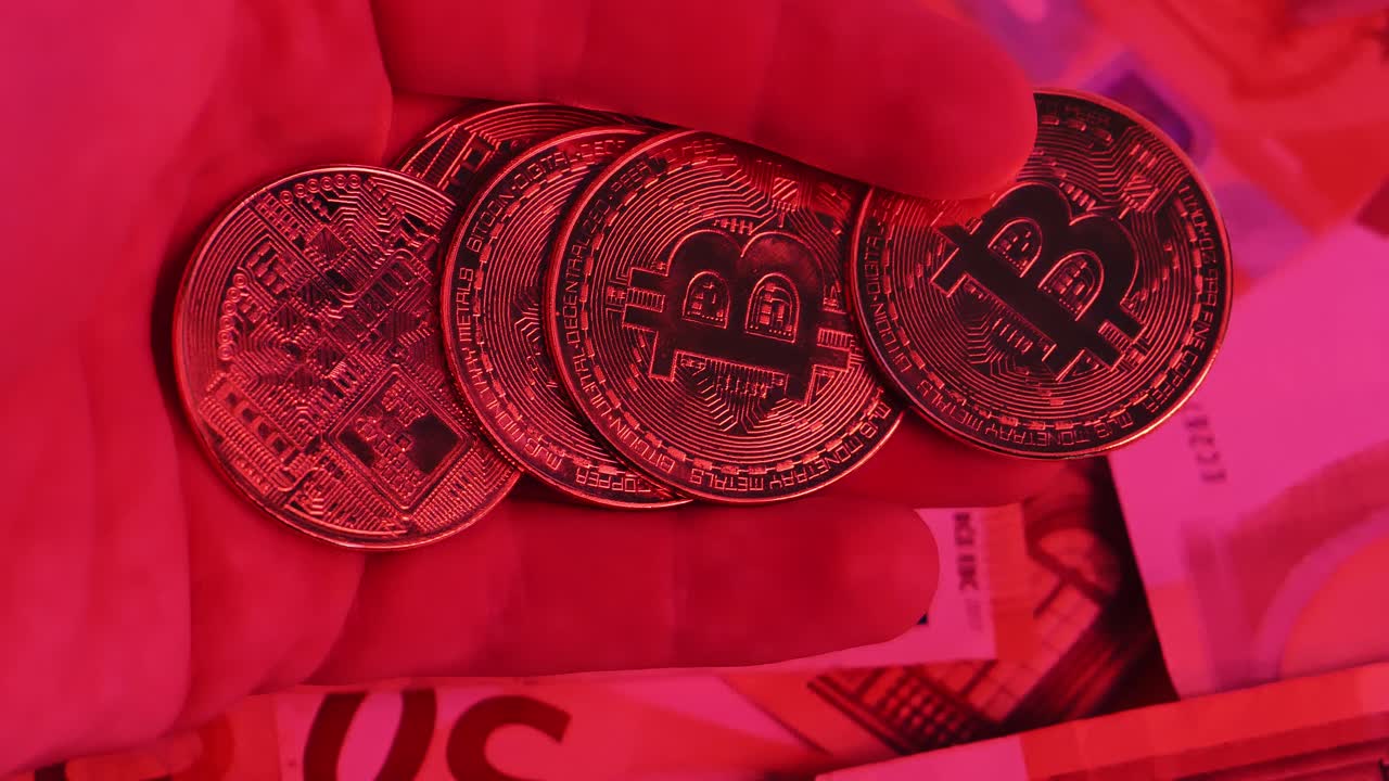 Dramatic shot of Bitcoin over spinning euro cash, red warning of economic crisis