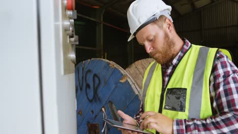 male worker controlling control box while using digital tablet 4k