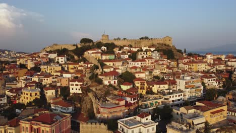 retiro aéreo y revela una antigua fortaleza en una colina con arquitectura tradicional en kavala, grecia