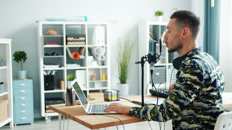 man recording podcast in home office