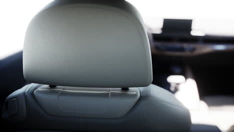 close-up of a modern car's grey leather headrest