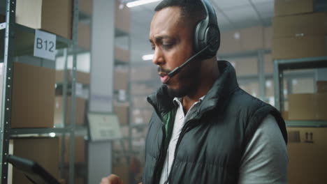 warehouse worker on tablet with headset