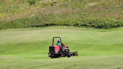 lawn mower operating in a grassy field