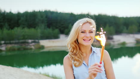 attractive blonde with fireworks and sparkler in hand to have fun