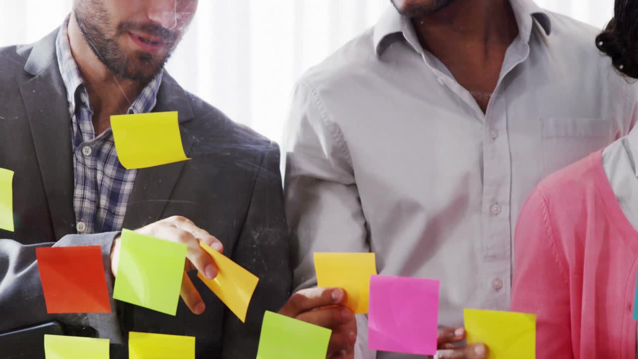 Businesspeople interacting over sticky notes