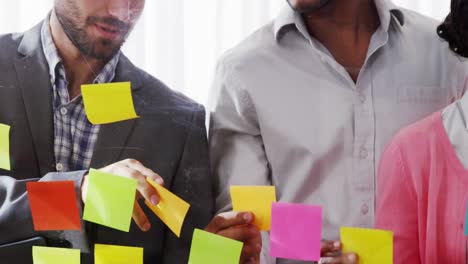 businesspeople interacting over sticky notes