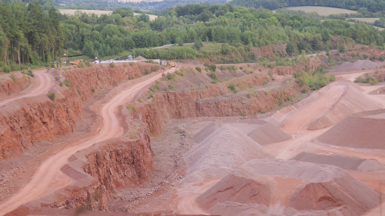 Panning View Over Empty Quarry Roads Used for Excavating Natural Resources Like Sand Stone Gravel to Use for Building Materials. Heavy Mining Excavating Industry Surrounded by Natural Environment