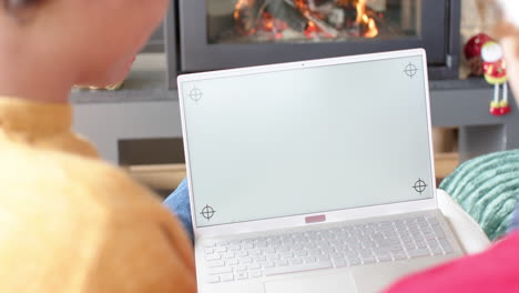 Diverse-gay-male-couple-using-laptop-with-copy-space-on-screen-for-video-call-at-home,-slow-motion