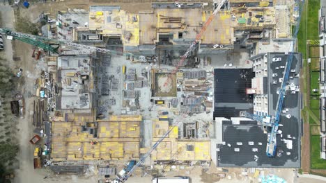 aerial view of construction site with crane and building