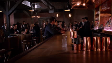 people socializing at a lively bar with warm lighting