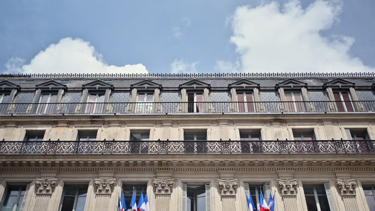 Multiple French flags hanging on a building in Paris, France