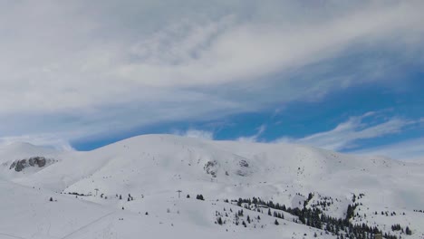 Mountain-with-ski-resort,-covered-with-snow