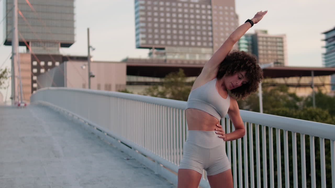 Woman Stretching on City Bridge