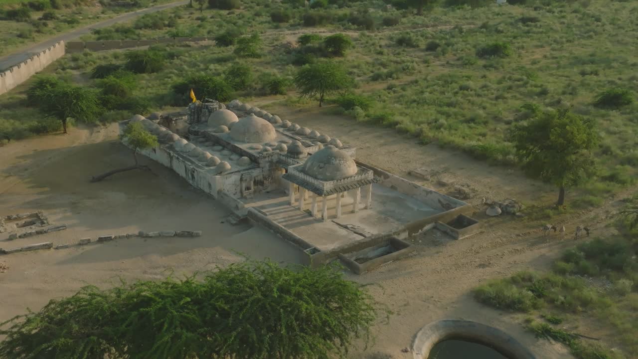 Capturing the serene beauty of a historic jaina temple amidst the vast. Arid landscape of tharparkar. Pakistan. Showcasing intricate architecture and peaceful surroundings from an aerial perspective