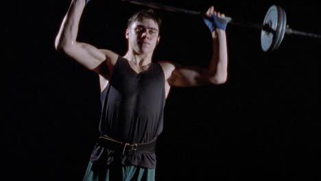 a young man lifting weights over his head