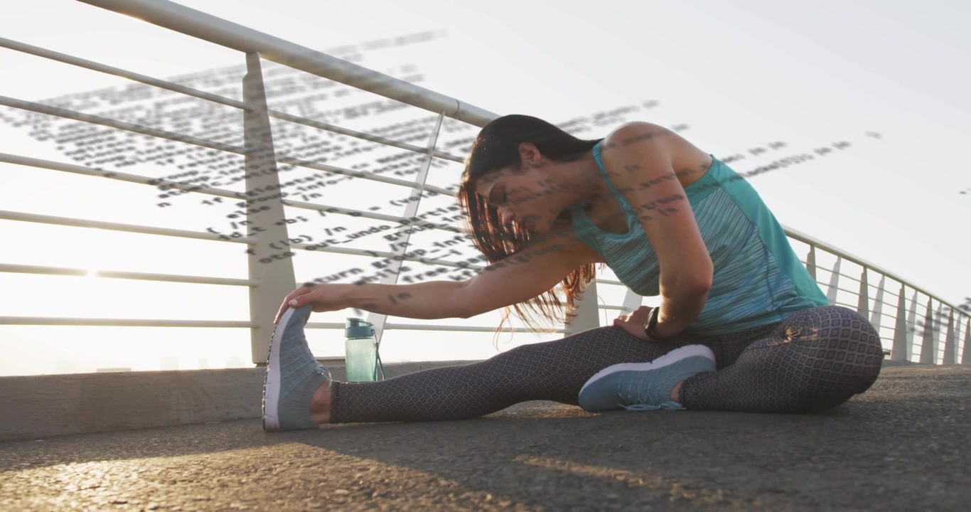 Female athlete starting fitness warmup, sitting and reaching toward toes, bottle near railing