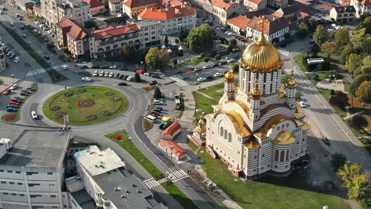 Aerial drone view of the Fagaras, Romania. Church of the Saint John the Baptist and Fagaras Citadel, buildings, roads with cars, greenery