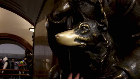 rubbing the famous dog’s nose for good luck in metro moscow