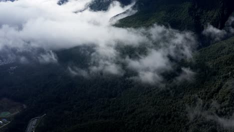 Cloudy-Cangshan-mountain-range-above-Dali-city,-Yunnan-China,-high-aerial-view