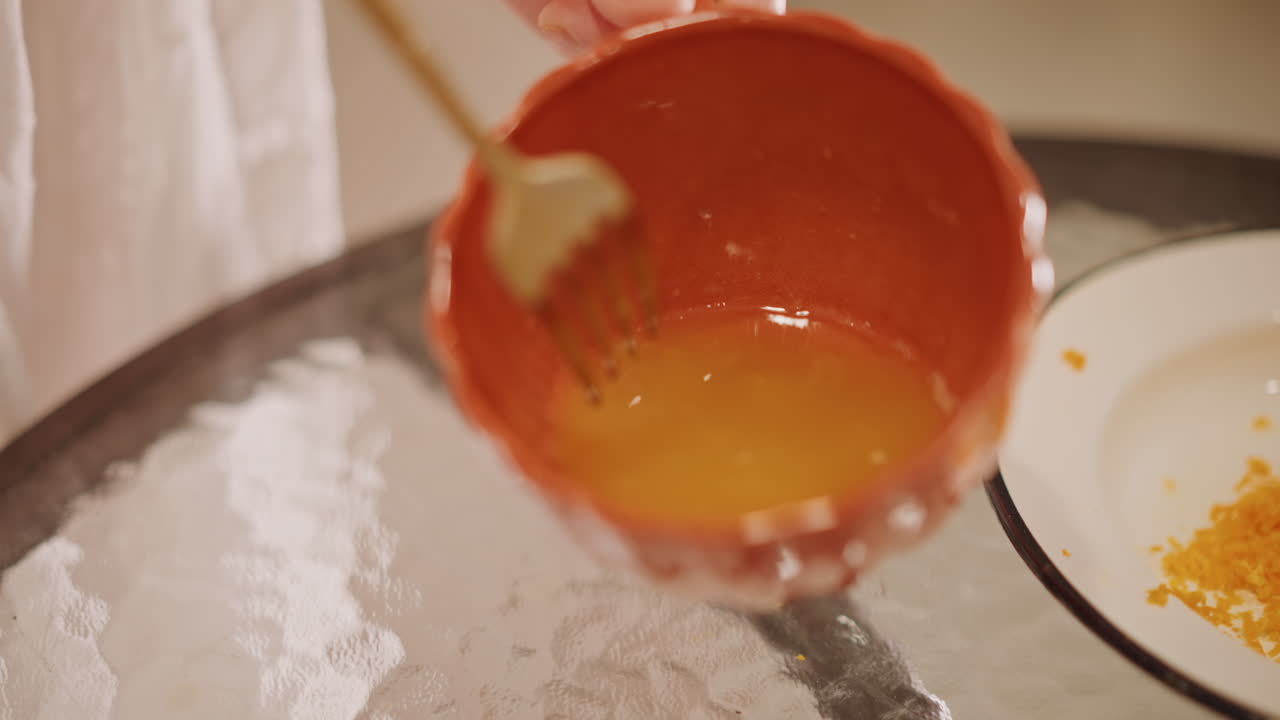 Careful check of pastry before baking. Calm kitchen scene with prepared pumpkin filling ready. Routine inspection process of pastry and pumpkin glaze before assembly in baking process