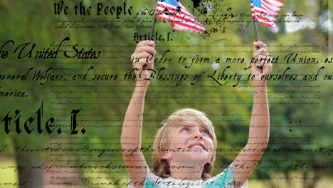 child holding out american flags and the written constitution of the united states