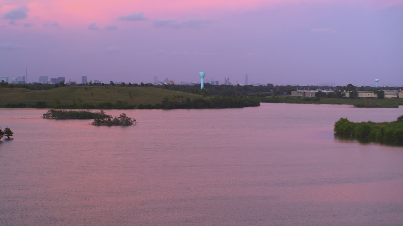 4K Wide Angle Drone View of Bayou and Downtown Houston in Background