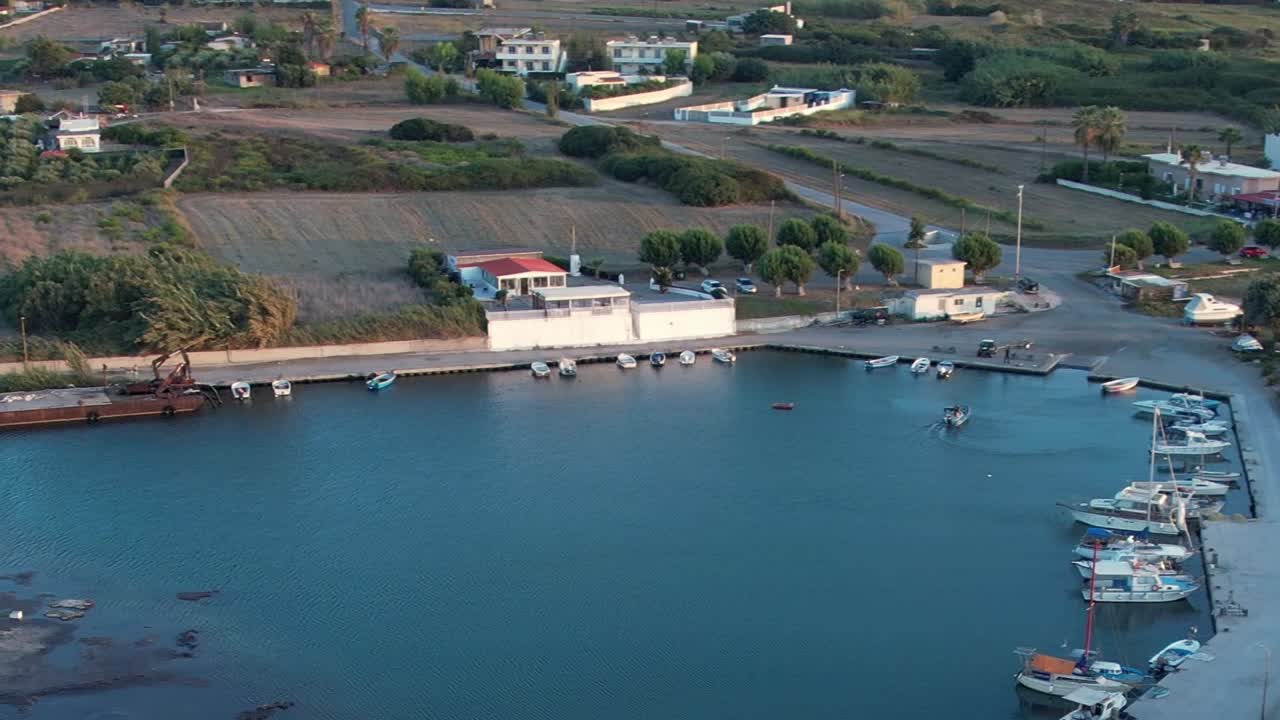 Stunning aerial view of a peaceful harbor in Greece during sunny weather
