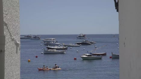 static boats in the ocean, coast hall in foreground, static shot