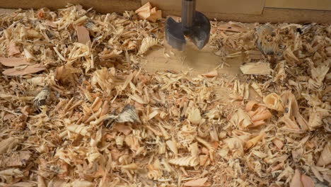 Slow panning clip of wood shavings on a drill press