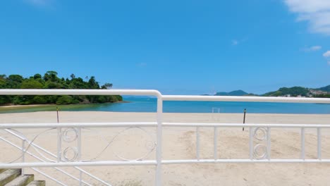 Side-view-of-white-guardrail-on-a-beautiful-beach-in-Angra-dos-Reis