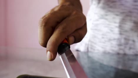 young man with chopping board and chopping knife making salad