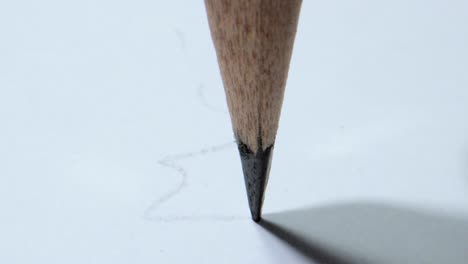 drawing lines on paper with pencil closeup