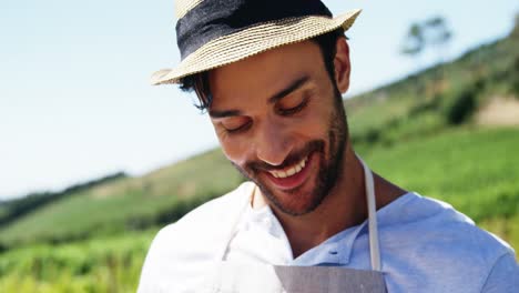 Portrait-of-happy-man-holding-basket-full-of-fresh-apples