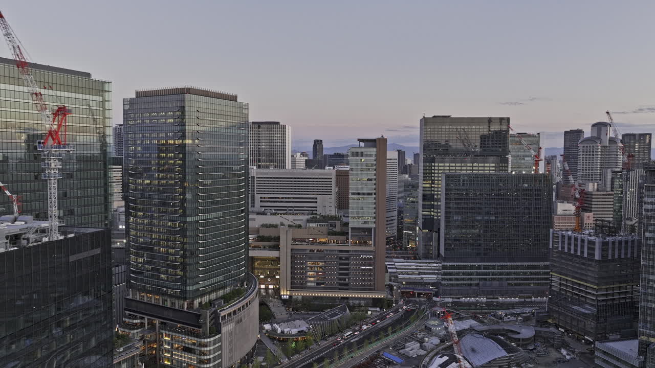 Osaka Japan Aerial v8 flyover Ofukacho, birds eye view capturing Umeda railway station, a major transportation hub and Kita ward downtown cityscape at dusk - Shot with Mavic 3 Pro Cine - Oct 8th 2023