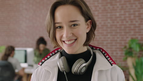 portrait of stylish young caucasian woman smiling happy independent female business woman in contemporary internet cafe workspace