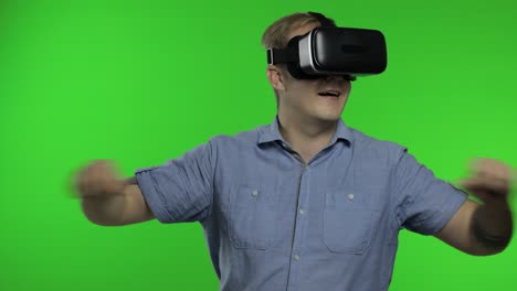 man using vr app helmet to play simulation game, drawing. guy watching virtual reality 3d video