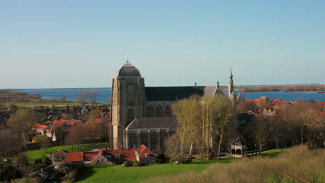 aerial: the historical town of veere with an old harbour and churches, on a spring day