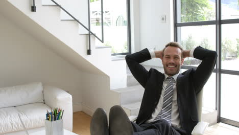 businessman smiling and relaxing on a chair