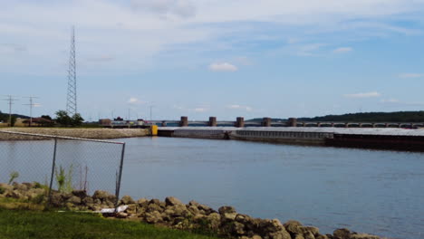 Zoom-out-view-of-a-barge-slowly-through-Lock-No