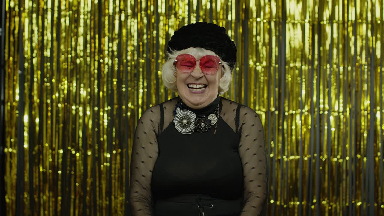 Happy senior old woman laughing out loud after hearing anecdote, funny joke, positive lifestyle