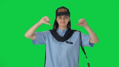 Upset-Indian-female-security-guard-showing-thumbs-down-Green-screen
