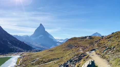 Mountain-Freedom:-Matterhorn-Mountain-Landscape-Near-Rotenboden-and-Gornergart,-Switzerland,-Europe-|-Shaky-Movement-Down-Trail-Towards-Scenic-Lake-and-Reverse,-Hiking