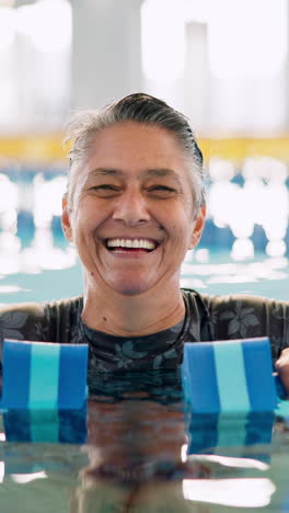 smiling senior woman exercising in a swimming pool