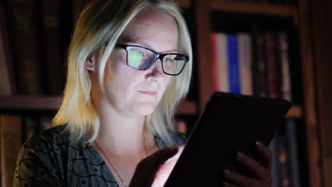 woman working on tablet late at night