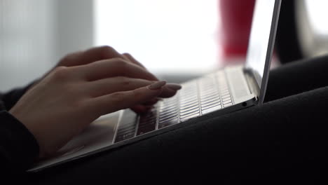 Female-hands-press-keys-on-the-keyboard-of-a-MacBook-with-a-Russian-layout