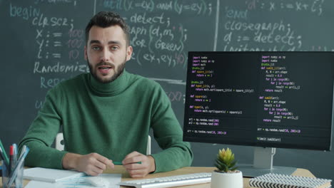 man teaching computer programming in classroom